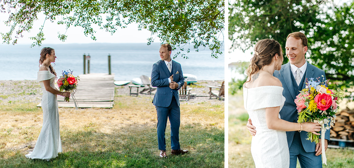 bride and groom standing in front of seneca lake see each other on their wedding day for the first time