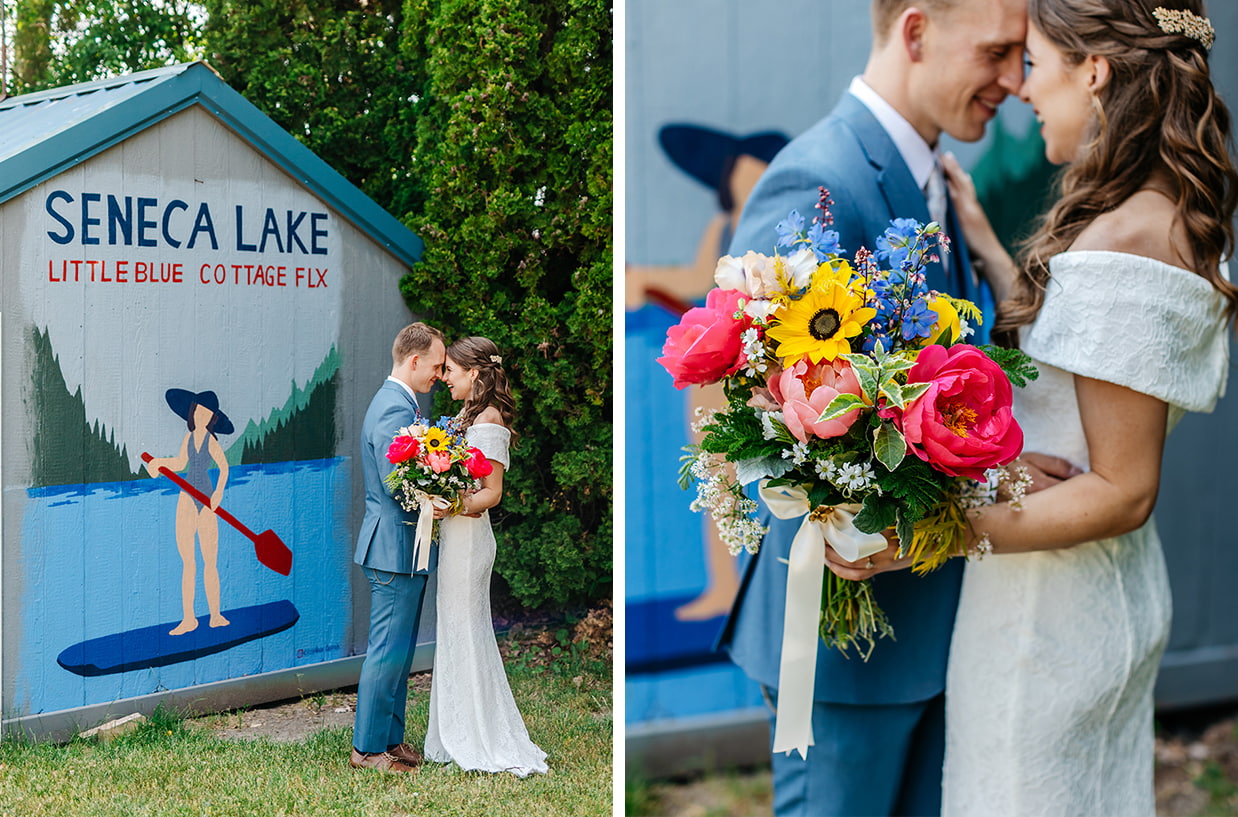 Bride and groom stand in front of mural for little blue cottage flx on seneca lake