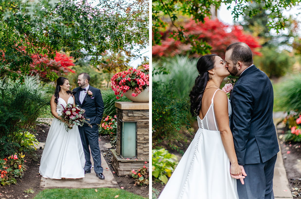 Bride and Groom stand in lush, colorful garden at The Lodge at Turning Stone and share a kiss